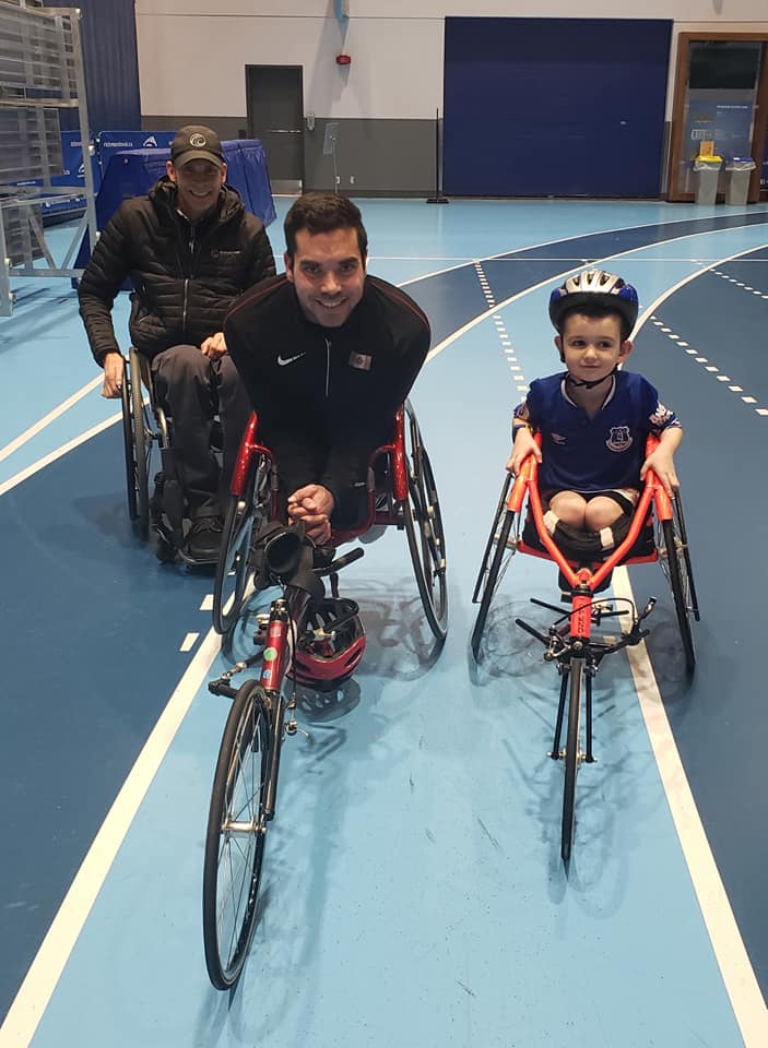 Brody racing in a wheelchair on a track